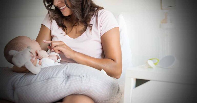 Can you wash boppy pillow? Mother with newborn baby on a nursing pillow.